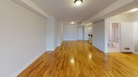Located at 75 Lackawanna Ave in Totowa, NJ, this well-appointed one-bedroom, one-bathroom residence offers a thoughtfully designed single-floor layout. Warm-toned hardwood floors run seamlessly throughout, lending a cohesive and inviting feel to every room.

The expansive open living area is generously proportioned, bathed in natural light from large windows, and flows effortlessly from one end of the unit to the other — ideal for both relaxing and entertaining. Neutral-toned walls complement the bright, airy atmosphere throughout.

The kitchen is a functional highlight, featuring rich dark-wood cabinetry, granite countertops with a stone tile backsplash, a gas range, built-in microwave, and a stainless steel sink — a well-equipped space for everyday cooking.

The bedroom is comfortably sized with continued hardwood flooring and access to a walk-in closet, offering ample storage. The full bathroom is clean and modern, appointed with a granite-topped white vanity, tile flooring, and a tub/shower combination with sliding glass doors.

A dedicated in-unit laundry closet houses a full-size washer and dryer, adding everyday convenience. The overall design is clean, modern, and move-in ready, making this a practical and comfortable home in Totowa, NJ.