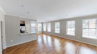 Located at 602 W 29th Avenue in Denver, Colorado, this single-floor residence offers a well-designed layout with a thoughtful blend of modern finishes and comfortable living spaces. The open-concept living and dining area is a standout feature, boasting rich hardwood flooring that reflects natural light pouring in through a generous row of windows fitted with blinds. Crown molding adds a refined architectural touch throughout. A white-mantled fireplace anchors the living area, providing both a functional focal point and a warm, inviting ambiance.

The kitchen is designed for both style and functionality, featuring dark espresso cabinetry, white countertops, and a full suite of stainless steel appliances, including a range, microwave, and refrigerator. The space flows seamlessly into the main living area via a peninsula counter.

The bedrooms are carpeted for comfort and each is equipped with a ceiling light fixture and window access for natural light and ventilation. The bathrooms are well-appointed, with one featuring a long vanity with dark cabinetry and hardwood flooring, and another offering a soaking tub alongside a separate glass-enclosed shower, both finished with white tile. The overall palette of soft grays and whites lends the home a clean, contemporary aesthetic throughout.