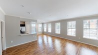 Located at 602 W 29th Avenue in Denver, Colorado, this single-floor residence offers a well-designed layout with a thoughtful blend of modern finishes and comfortable living spaces. The open-concept living and dining area is a standout feature, boasting rich hardwood flooring that reflects natural light pouring in through a generous row of windows fitted with blinds. Crown molding adds a refined architectural touch throughout. A white-mantled fireplace anchors the living area, providing both a functional focal point and a warm, inviting ambiance.

The kitchen is designed for both style and functionality, featuring dark espresso cabinetry, white countertops, and a full suite of stainless steel appliances, including a range, microwave, and refrigerator. The space flows seamlessly into the main living area via a peninsula counter.

The bedrooms are carpeted for comfort and each is equipped with a ceiling light fixture and window access for natural light and ventilation. The bathrooms are well-appointed, with one featuring a long vanity with dark cabinetry and hardwood flooring, and another offering a soaking tub alongside a separate glass-enclosed shower, both finished with white tile. The overall palette of soft grays and whites lends the home a clean, contemporary aesthetic throughout.