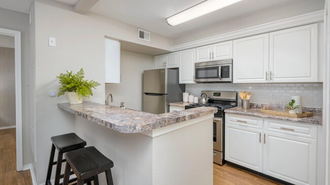 Embrace modern kitchens with gleaming stainless-steel appliances, dazzling granite-style countertops, and stylish subway tile backsplashes. - The Oasis at 1800