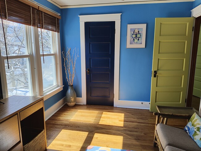 Living Room, windows look into tree top and over garden. - 413 N Geneva St