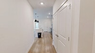 Located at 157 Talley Crossing in Athens, GA, this well-designed single-story home offers three bedrooms, two bathrooms, and a thoughtful layout across a comfortable footprint. The open-concept kitchen and living area serves as the heart of the home, featuring light hardwood-style flooring, recessed lighting, and a sleek kitchen island topped with granite countertops. The kitchen is equipped with stainless steel appliances, soft gray shaker-style cabinetry, a white subway tile backsplash, and stylish black pendant lights that add a modern touch. The living area receives ample natural light through large windows and a glass-panel exterior door, complemented by a ceiling fan overhead. The three bedrooms offer plush carpeting and ceiling fans, providing comfortable, functional spaces. The primary bedroom is a generously sized retreat. The two bathrooms are finished with clean, modern details — one features a soaking tub with a subway-tiled surround and brushed nickel fixtures, while the other includes a glass-enclosed walk-in shower with matching tile work and a granite-topped vanity. Additional conveniences include two closets and a dedicated laundry room, rounding out this move-in-ready home.