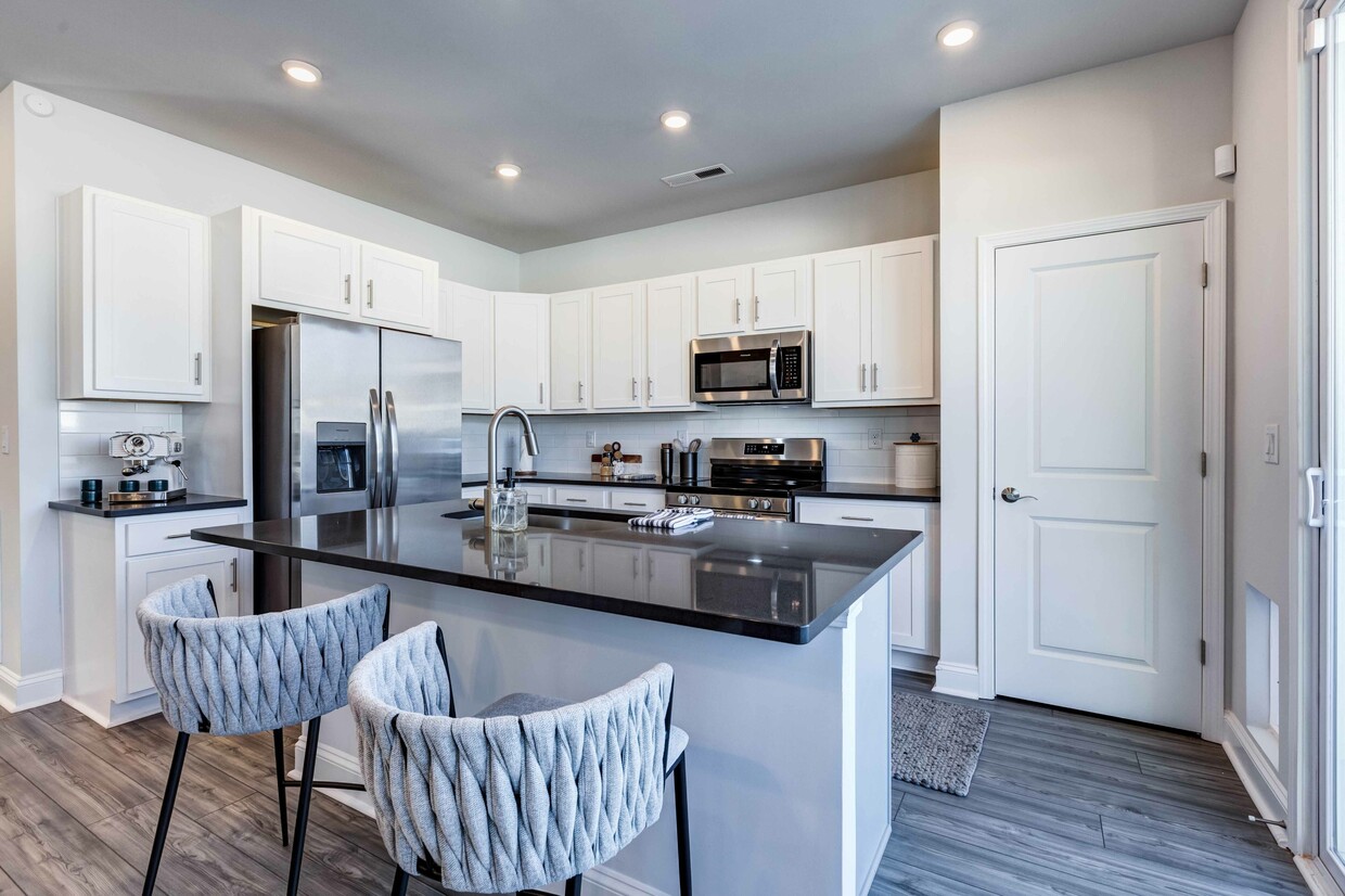 Gather and dine with Amavi Sherrills Ford's kitchens featuring a stylish kitchen island, offering room for bar seating. - Amavi Sherrills Ford