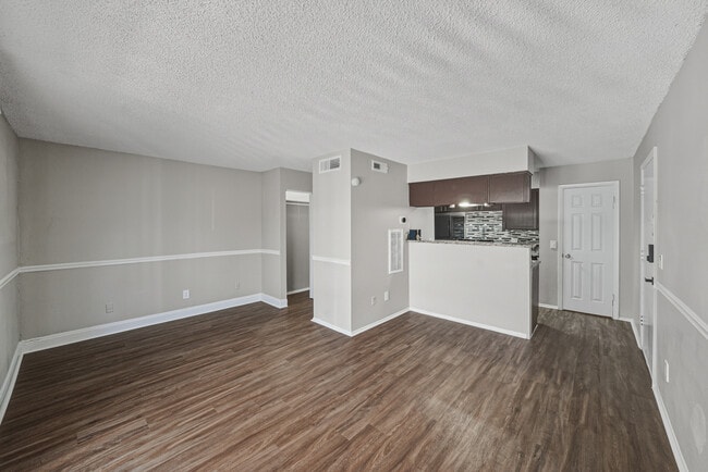 Spacious open-concept living area with modern flooring - Magnolia Apartments