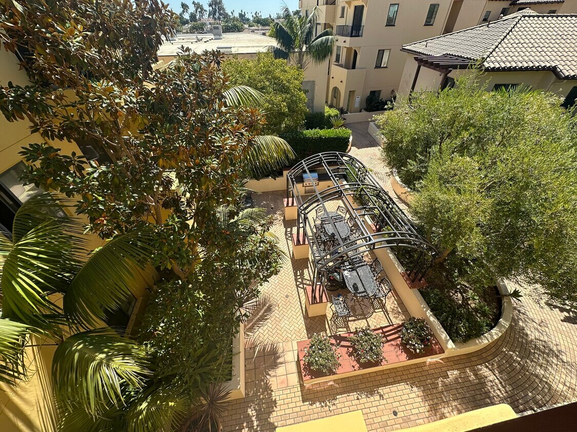 View from front door down into quiet, seclued, courtyard area with BBQ and gazebo. - 130 N Garden St