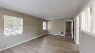 Located at 3636 Spottswood Ave in Memphis, TN, this single-floor, 3-bedroom, 1-bathroom home offers a practical and cohesive layout. Consistent wood-look laminate flooring and neutral taupe wall tones run throughout, creating a unified and clean aesthetic. Textured ceilings and white baseboards add a classic finishing touch to each room.

The main living area is generously proportioned, featuring multiple windows that allow natural light to fill the space, along with ceiling-mounted HVAC vents for year-round comfort. The kitchen is well-equipped with abundant white cabinetry, laminate countertops, a double-basin sink, and white appliances including a range, refrigerator, and dishwasher. A door in the kitchen provides direct exterior access, and a window overlooks the outdoors.

The spacious primary bedroom offers ample room and includes a closet, natural light from a window, and a floor vent. The two additional bedrooms are similarly appointed with windows and closets, making each room functional and comfortable. An interior hallway features a unique interior window, connecting rooms with an open visual flow. The full bathroom includes a tub-shower combination with sliding glass doors and white tile surround.