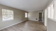 Located at 3636 Spottswood Ave in Memphis, TN, this single-floor, 3-bedroom, 1-bathroom home offers a practical and cohesive layout. Consistent wood-look laminate flooring and neutral taupe wall tones run throughout, creating a unified and clean aesthetic. Textured ceilings and white baseboards add a classic finishing touch to each room.

The main living area is generously proportioned, featuring multiple windows that allow natural light to fill the space, along with ceiling-mounted HVAC vents for year-round comfort. The kitchen is well-equipped with abundant white cabinetry, laminate countertops, a double-basin sink, and white appliances including a range, refrigerator, and dishwasher. A door in the kitchen provides direct exterior access, and a window overlooks the outdoors.

The spacious primary bedroom offers ample room and includes a closet, natural light from a window, and a floor vent. The two additional bedrooms are similarly appointed with windows and closets, making each room functional and comfortable. An interior hallway features a unique interior window, connecting rooms with an open visual flow. The full bathroom includes a tub-shower combination with sliding glass doors and white tile surround.