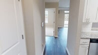 Located at 3100 Ashley Town Center in Charleston, South Carolina, this single-floor residence offers a clean, contemporary aesthetic throughout. The interior is unified by wood-look plank flooring in the main living and hallway areas, complemented by crisp white trim and neutral warm-gray walls that create a cohesive, move-in-ready atmosphere.

The kitchen is a functional highlight, featuring white shaker-style cabinetry, granite countertops with subtle veining, stainless steel appliances, and a stainless undermount sink. A skylight overhead brightens the space, and a dedicated pantry door provides additional storage.

The living area is finished with crown molding, a ceiling fan, and a sliding glass door that opens to a private balcony, inviting natural light and outdoor views. Hallways connect to well-proportioned bedrooms, each carpeted and equipped with ceiling fans and multiple windows. The primary bedroom includes direct access to a private bathroom featuring a soaking tub, wood-look tile flooring, a white vanity with ample counter space, and a walk-in closet with wire shelving throughout. Additional bedrooms offer generous closet space and natural light, making each room practical and comfortable.