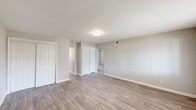 Located at 2050 Austell Rd SW in Marietta, Georgia, this single-floor, three-bedroom, two-bathroom home offers a practical and well-organized layout with clean, neutral finishes throughout. The living room serves as the heart of the home, featuring durable wood-look flooring, soft neutral wall tones, and flush-mount ceiling lighting that creates a bright, welcoming atmosphere. A hallway connects the main living areas to the private quarters, maintaining a clear and efficient flow throughout the space. The kitchen is outfitted with crisp white cabinetry, granite-look countertops, and wood-look flooring that carries through from the living area, complemented by a full-size refrigerator and ample cabinet storage. The three bedrooms are carpeted for comfort, each featuring neutral walls and ceiling lighting. The primary bedroom offers a generous footprint with a closet and natural light from a window with exterior views. The two bathrooms are finished with white tile surrounds — one featuring a tub-shower combination and the other a dedicated walk-in shower, both accented with chrome fixtures. Throughout the home, consistent use of neutral tones, clean white trim, and cohesive flooring choices create a tidy, move-in-ready environment suited for comfortable everyday living.