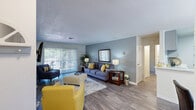 Located in Scottsdale, Arizona, this single-story 2-bedroom, 3-bathroom home offers a thoughtfully designed layout that maximizes comfort and functionality. The open living and dining area serves as the heart of the home, featuring wood-look flooring, neutral gray wall tones, and large sliding glass doors that flood the space with natural light and provide views of the outdoor area. The adjoining dining nook accommodates a round table and benefits from a generous window with horizontal blinds.

The galley-style kitchen is well-equipped with gray cabinetry, quartz-style countertops, a double basin sink, subway tile backsplash, and stainless steel appliances including a gas range and refrigerator. Wood-look flooring continues throughout.

The spacious primary bedroom features plush carpeting and ample room for large furnishings. The second bedroom also offers carpeted flooring and a built-in closet. Both are served by well-appointed bathrooms featuring gray vanities, framed mirrors, and light quartz countertops. A hallway connects the bedrooms and bathrooms, maintaining a clean and organized flow throughout.

This Scottsdale home presents a practical, modern living environment with cohesive finishes and a functional single-floor design ideal for comfortable everyday living.