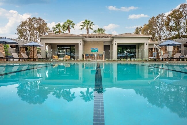 Resort-Style Pool at Camino Real Apartments with Clubhouse and Lounge Chairs - Camino Real Apartments