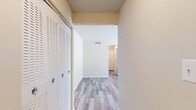 This well-designed one-bedroom apartment in Newport Village offers a blend of comfort and functionality within its 760 square feet. The open floor plan maximizes space utilization, with two living room areas providing versatile living arrangements. The kitchen stands out with its modern aesthetic, featuring dark wood cabinetry, stainless steel appliances, and a stylish backsplash. Granite countertops add a touch of elegance to the space.

The bedroom, measuring 170 square feet, is generously sized and includes a ceiling fan for added comfort. Large closets with louvered doors offer abundant storage. The bathroom is clean and functional with a shower/tub combination. An in-unit laundry room with full-sized washer and dryer adds convenience to daily living.

Throughout the apartment, a mix of flooring types can be found. The living areas and kitchen feature durable wood-look flooring, while the bedroom is carpeted for a cozy feel. Windows in various rooms allow for natural light, and the overall neutral color palette creates a bright, airy atmosphere.

The apartment's layout includes two hallways for easy navigation between rooms. With its modern amenities and thoughtful design, this Newport Village one-bedroom offers a comfortable living space suited for various lifestyles.