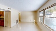 Located at 300 Charles G Stephenson Dr in Winchester, Kentucky, this single-floor, 2-bedroom, 1-bathroom residence offers a practical and well-organized layout. The living room is a bright, open space with light-toned walls, a textured ceiling, and a window that allows natural light to fill the room. The galley-style kitchen is efficiently designed, featuring warm oak cabinetry, gray laminate countertops, a double stainless steel sink, and white appliances including a range and refrigerator. Light flooring ties the space together cohesively. The two bedrooms are each served by windows that bring in natural daylight and views of the surrounding neighborhood. The primary bedroom is comfortably sized and includes closet access with direct proximity to the full bathroom. The second bedroom offers a quiet, versatile space suitable for various uses. The bathroom includes a tiled tub-shower combination with chrome fixtures, a toilet, and a vanity sink, finished with stone-look tile flooring. A central hallway connects the rooms efficiently, and with six closets distributed throughout, storage is a notable strength of this home. Textured ceilings and neutral warm-toned walls are consistent throughout, giving the space a clean, uniform feel.
