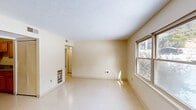 Located at 300 Charles G Stephenson Dr in Winchester, Kentucky, this single-floor, 2-bedroom, 1-bathroom residence offers a practical and well-organized layout. The living room is a bright, open space with light-toned walls, a textured ceiling, and a window that allows natural light to fill the room. The galley-style kitchen is efficiently designed, featuring warm oak cabinetry, gray laminate countertops, a double stainless steel sink, and white appliances including a range and refrigerator. Light flooring ties the space together cohesively. The two bedrooms are each served by windows that bring in natural daylight and views of the surrounding neighborhood. The primary bedroom is comfortably sized and includes closet access with direct proximity to the full bathroom. The second bedroom offers a quiet, versatile space suitable for various uses. The bathroom includes a tiled tub-shower combination with chrome fixtures, a toilet, and a vanity sink, finished with stone-look tile flooring. A central hallway connects the rooms efficiently, and with six closets distributed throughout, storage is a notable strength of this home. Textured ceilings and neutral warm-toned walls are consistent throughout, giving the space a clean, uniform feel.