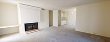 Located at 1530 4th St in Sacramento, CA, this single-floor residence offers 930 square feet of living space across three bedrooms, two bathrooms, a hallway, and a dedicated closet. The open living area is highlighted by a classic fireplace and a sliding glass door fitted with vertical blinds, allowing natural light to fill the carpeted space. An adjacent dining area opens into the kitchen, which features white cabinetry, a ceiling fan, and light countertops. The primary bedroom spans 180 square feet and includes direct access to a bathroom and a walk-in closet with built-in hanging rods and carpeted flooring. The two secondary bedrooms are also carpeted and each features large windows with vertical blinds that invite ample natural light. Both bathrooms are finished with light wood-look vinyl flooring, white vanity cabinetry, extended countertops, large mirrors, and a combined tub-shower in the full bath. Textured ceilings are consistent throughout the unit, contributing to the home's classic residential character. The neutral color palette across all rooms provides a clean, versatile canvas throughout this practical Sacramento home.