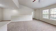 Located at 1551 W 78th St S in Tulsa, Oklahoma, this two-story home offers 2 bedrooms, 3 bathrooms, and a thoughtfully designed layout spread across two floors. The main living level hosts the majority of the home's square footage, while the ground floor provides an attached garage with a built-in opener, concrete flooring, and a window that allows natural light to filter in.

The kitchen is well-equipped with stainless steel appliances — including a refrigerator, range, microwave, and dishwasher — complemented by white cabinetry, white tile backsplash, and light tile flooring that transitions into carpeted living areas.

The primary bedroom is generously sized, featuring soaring vaulted ceilings, a ceiling fan, and a window that brings in natural light. It is served by a dedicated closet outfitted with wire shelving systems and plush carpet underfoot. Additional bedrooms and closets provide flexible storage throughout the home.

The bathrooms include tiled tub-and-shower combinations with clean, neutral finishes. A hallway and staircase connect the home's levels efficiently. With three closets total and a practical floor plan, this home balances comfort and functionality in a residential Tulsa neighborhood.