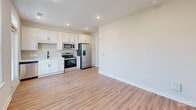 Located at 2405 Herrons Nest Pl NW in Concord, NC, this one-bedroom, one-bathroom unit offers a thoughtfully designed single-floor layout that makes efficient use of its cozy footprint. Warm wood-look luxury vinyl plank flooring runs throughout, tying together each area with a clean, cohesive aesthetic.

The kitchen is a standout feature, outfitted with crisp white shaker-style cabinetry, a stainless steel appliance suite including a range, microwave, and French door refrigerator, and recessed lighting overhead. It opens directly to the main living area, creating an inclusive, open feel.

The spacious bedroom is generously proportioned relative to the overall unit, offering ample room for living and relaxing. A ceiling fan provides year-round comfort, and natural light filters in through windows that view toward the entry. The room connects seamlessly to the rest of the unit via a central hallway.

The bathroom is finished with a white vanity featuring shaker-style cabinetry and drawers, a framed mirror, matte black fixtures and hardware, and wood-look flooring that continues the home's consistent design language. Recessed and vanity lighting ensure the space is well-lit.

Throughout the unit, white walls, white panel doors with matte black hardware, and clean trim details create a modern yet inviting atmosphere well-suited for comfortable everyday living.