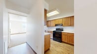 Located at 2000 White Swan Drive in Rochester, NY, this two-story, 3-bedroom, 2-bathroom home offers a practical and well-organized layout spread across two floors. The main level features a combined living and dining area filled with natural light from multiple windows, with direct outdoor access through a glass-panel door. Neutral carpet flooring and clean white walls create a bright, open atmosphere throughout. The kitchen is equipped with warm oak cabinetry, light countertops, a black gas range, a dishwasher, and a double sink beneath a window — providing ample workspace and storage. A convenient half bathroom on the main level includes a vanity with under-cabinet storage, a mirror, and hardwood-style flooring. Upstairs, three carpeted bedrooms offer comfortable living spaces, each benefiting from natural light. The primary bedroom includes access to a dedicated walk-in closet with wire shelving, while additional bedrooms are served by their own closets. In total, five closets are distributed throughout the home, ensuring excellent storage capacity. Two staircases and well-connected hallways contribute to efficient flow between floors. The overall design is clean and functional, making this a solid, move-in ready home in the Rochester area.