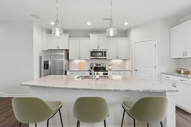 Paquete de actualización de cocina con gabinetes blancos, placa para salpicaduras de azulejos de diseño e iluminación debajo de los gabinetes y encimeras de granito. - Avalon Townhomes Brier Creek