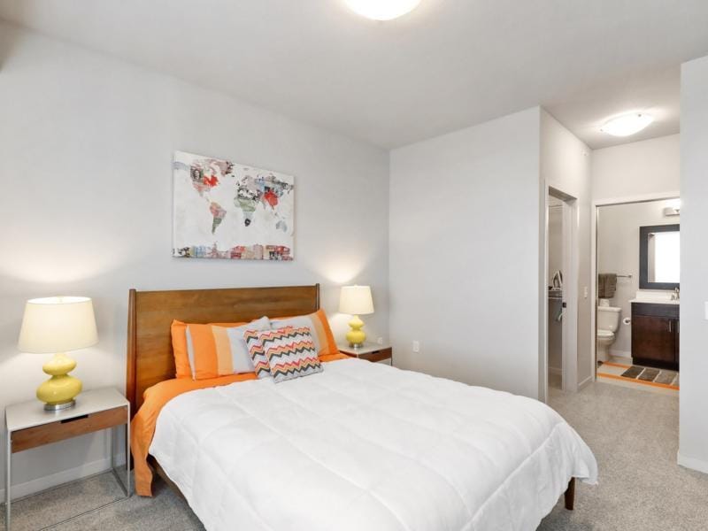 Cozy bedroom with a queen-size bed, nightstands, and a glimpse of the bathroom.