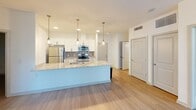 This 4-bedroom, 2-bathroom apartment in Chester, VA offers a thoughtfully designed single-floor layout with a clean, contemporary aesthetic. The open-concept kitchen is a standout feature, boasting a large granite-topped island with an undermount sink, stainless steel appliances, white cabinetry with a tile backsplash, and stylish pendant lighting. Light wood-style flooring flows throughout the main living areas, while plush carpeting adds comfort to the bedrooms. Both bathrooms are finished with granite vanity countertops, white cabinetry, and modern brushed-gold fixtures. The bedrooms are bright and well-proportioned, with the primary bedroom offering generous space. Two closets provide ample storage throughout the unit.