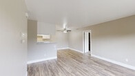 Located at 1700 N Tully Rd in Turlock, California, this single-floor 2-bedroom, 2-bathroom unit offers a practical and well-appointed layout. The open-concept living area is finished with light wood-style laminate flooring throughout and features a ceiling fan, neutral warm-toned walls, and clean white baseboards that contribute to a bright, airy atmosphere. A half-wall peninsula seamlessly connects the living space to the galley-style kitchen, which is equipped with white cabinetry featuring brushed nickel hardware, a gas range, a full-size refrigerator, and a stainless steel sink — all set on matching wood-style flooring with ample upper and lower cabinet storage.

The primary bedroom is a comfortable retreat featuring plush carpeting, a ceiling fan, and a sliding glass door that opens to a private balcony with outdoor views. A spacious walk-in closet with multi-rod shelving provides generous storage. The second bedroom is equally well-sized with carpeted flooring and its own closet. Both bathrooms are cleanly finished, with one featuring a full tub/shower combination and a window for natural light. A dedicated entrance and two closets throughout the unit round out this well-organized and move-in-ready home.