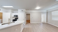 This well-appointed 2-bedroom, 2-bathroom residence in Houston, TX offers a thoughtfully designed single-floor layout with a clean, modern aesthetic throughout. Light wood-style flooring flows consistently across the living spaces, complementing the neutral gray and white color palette that gives the home a bright, cohesive feel.

The open kitchen is outfitted with white shaker cabinetry, quartz countertops, a subway tile backsplash, and a full suite of stainless steel appliances including a refrigerator, dishwasher, microwave, and range. The kitchen connects seamlessly to the living room, creating an open and functional common area with natural light from nearby windows.

The primary bedroom offers a generous footprint with crown molding, multiple windows with blinds, and access to a walk-in closet equipped with wire shelving systems for organized storage. The second bedroom also features a ceiling fan with light, a large window, and light-toned flooring. Both bathrooms feature white vanities with quartz counters, tub-shower combinations, and light wood-style flooring.

A dedicated in-unit laundry room with wire shelving provides added everyday convenience. The space combines practical functionality with clean, contemporary finishes throughout.