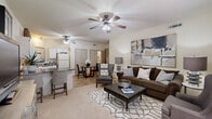 Located at 2800 SW Wagon Ave in Bentonville, AR, this single-floor, 2-bedroom, 1-bathroom residence offers a practical and comfortable layout designed for efficient living. The open-concept main area seamlessly connects the living room, dining space, and kitchen, creating a cohesive and welcoming atmosphere. The living room features plush carpeting, a ceiling fan, and a window that allows natural light to fill the space. The kitchen is equipped with white cabinetry, dark countertops, a full suite of appliances including a refrigerator, range, dishwasher, and built-in microwave, complemented by tile flooring and a pass-through window. The dining area, finished in tile, sits adjacent to the kitchen and provides easy access to the rest of the unit. Both bedrooms are carpeted and feature ceiling fans, windows with natural light, and easy closet access. The primary bedroom is a comfortable size with ample room for furnishings. A dedicated walk-in closet with wire shelving provides organized storage. The bathroom includes a tiled tub/shower combination with sliding glass doors, a vanity, and overhead cabinetry. A hallway connects the main living areas to the private bedroom wing, completing the thoughtful floor plan.