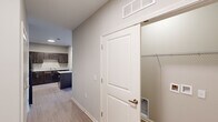 Located at W 51st Street in Chattanooga, Tennessee, this single-floor unit offers a thoughtfully designed layout with modern finishes throughout. The kitchen serves as a functional centerpiece, outfitted with rich dark cabinetry, granite-look countertops, black appliances including a refrigerator and range, and a double sink — all complemented by light wood-look flooring that carries seamlessly through the space.

The living and bedroom areas are generously proportioned, each featuring ceiling fans with light fixtures and windows fitted with horizontal blinds that allow for natural light and outdoor views. The neutral, warm-toned walls create a clean and inviting atmosphere throughout.

Storage is a notable highlight, with multiple walk-in closets equipped with wire shelving systems that maximize organization and usability. The hallway connecting the spaces provides convenient access to each room and includes additional closet access.

The bathroom is finished to a high standard, featuring large-format tile flooring, a glass-enclosed walk-in shower, a granite-topped vanity with dark cabinetry, and a wide mirror — delivering a polished, contemporary feel. The consistent use of coordinating materials and finishes across the unit contributes to a cohesive and modern aesthetic throughout this Chattanooga residence.