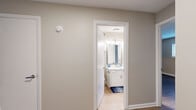 Located at 1157 Bell Road in Nashville, TN, this single-story, one-bedroom, one-bathroom unit offers a well-organized layout designed for efficient, comfortable living. Warm-toned, wood-look flooring flows consistently throughout the main living areas and bedroom, lending a cohesive and inviting aesthetic.

The living room is a standout space, featuring a sliding glass door that floods the room with natural light and opens to a view of lush greenery outside. A secondary window further brightens the area, making it feel open and airy. Neutral taupe walls provide a versatile backdrop throughout the unit.

The galley-style kitchen is thoughtfully appointed with crisp white cabinetry, white countertops, and a suite of stainless steel appliances including a refrigerator, electric range, and microwave. Light wood-look flooring and recessed lighting give the kitchen a clean, functional feel. A dedicated laundry area is conveniently accessible directly from the kitchen.

The bedroom offers a comfortable and quiet retreat, with a window dressed in blinds that allows natural light while maintaining privacy. A hallway connects to the full bathroom, which features white cabinetry with ample storage, a well-lit vanity mirror, a tub-shower combination, and tile flooring. A dedicated closet provides additional storage to complete this practical floor plan.