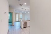 This 550 square foot apartment in Dallas, TX, offers a thoughtfully designed living space that maximizes functionality and style. The single-level floor plan comprises one bedroom, one bathroom, and an open-concept living area. The primary bedroom, measuring 110 square feet, features plush carpeting and a large window that allows natural light to flood the space. 

The kitchen is a standout feature, boasting sleek white cabinetry, stainless steel appliances, and a quartz countertop with a spacious island. The modern design is accentuated by pendant lighting and a subway tile backsplash. Light wood-look flooring extends throughout the main living areas, creating a seamless and contemporary aesthetic.

The bathroom continues the modern theme with a large vanity, ample storage, and a combination tub-shower with stylish tile work. A well-organized closet space provides additional storage solutions. The apartment's neutral color palette and clean lines create a bright, airy atmosphere that can easily be personalized to suit individual tastes.

Energy-efficient features include recessed LED lighting and window blinds for light control. The property's location at 9501 El Centro Dr offers convenient access to urban amenities while providing a comfortable and stylish living environment.