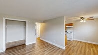 Located at 322 W 65th St in Davenport, Iowa, this single-floor unit offers three bedrooms, one bathroom, and a practical, efficiently organized layout. The galley-style kitchen is well-appointed with warm honey-toned wood cabinetry lining both walls, granite-look countertops, a double-basin sink, and white appliances including a coil-top electric range and refrigerator. Wood-look plank flooring runs through the kitchen and dining area, providing a clean, durable surface. The adjacent living and dining areas offer an open feel with neutral walls and a mix of carpet and plank flooring. Three carpeted bedrooms provide comfortable retreats, with the secondary bedrooms featuring windows with blinds that invite natural light. The primary bedroom includes a walk-in closet with a full hanging rod and shelving above. The bathroom is equipped with a wood-vanity, white countertop, toilet, and a full tub-shower combination. Two hallways connect the rooms efficiently throughout the unit. Neutral tones and clean finishes give the space a move-in ready appearance, while the understated design offers flexibility for personalization.