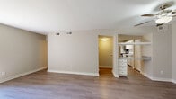 This well-organized single-floor, 2-bedroom, 3-bathroom home at 901 St Johns Wood Dr in Richmond, Virginia offers a comfortable and functional layout. The living area features durable hardwood-style flooring and neutral-toned walls, creating a clean, versatile canvas, with a ceiling fan adding to the room's comfort. A hallway connects the main living space to the rest of the home. The galley-style kitchen is efficiently designed, featuring white cabinetry, light stone-look countertops, stainless steel appliances including a refrigerator, gas range, microwave, and dishwasher, and light wood-style flooring. A window at the end of the kitchen brings in natural light, and an in-unit washer is conveniently located nearby. Both bedrooms are carpeted with neutral tones; the primary bedroom is a comfortable size and includes a dedicated vanity area with white cabinetry, a large mirror with Hollywood-style lighting, and closet space. The second bedroom features a wide window with views of lush greenery outside. Three bathrooms serve the home, each featuring clean white fixtures, tub/shower combos with chrome hardware, and wood-style flooring. The exterior is surrounded by green landscaping, adding a pleasant natural setting to this practical Richmond residence.