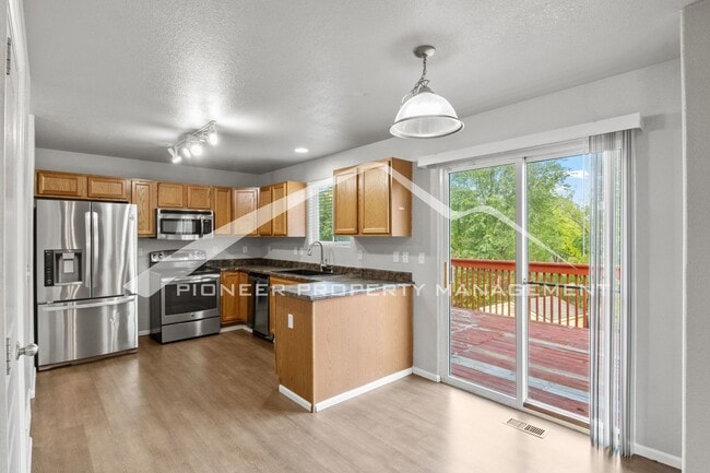 Photo - Spacious 4-Bed, 3.5-Bath Home with Walkout Basement, Oversized Deck enclosed yard, AC and 2-Car G...