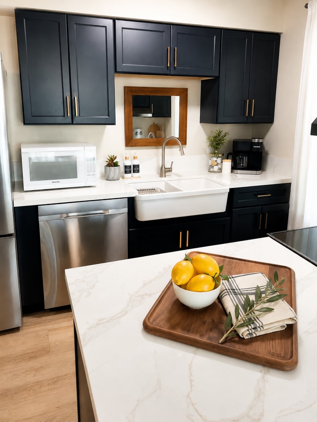 Kitchen with farmhouse sink, microwave, new cabinets, countertops, dishwasher, Keurig coffee maker. - 1795 W 28th St