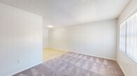Located at 7311 N Cedar Ct in Pinellas Park, Florida, this single-story, one-bedroom, one-bathroom home offers a practical and efficient layout across its single floor. The open-concept living and kitchen area forms the heart of the home, where light tile flooring transitions seamlessly between the two spaces. The kitchen is well-equipped with white cabinetry offering ample storage, dark countertops, a stainless steel sink, and white appliances including a refrigerator and electric range. A tray ceiling detail adds a touch of architectural interest to the kitchen area. The living room features plush carpeting, a textured ceiling, and a front-facing window that brings in natural light and outdoor views. The bedroom is a comfortable, carpeted retreat featuring a window and sliding glass door that opens to the outdoors, filling the room with natural light. A louvered closet door provides convenient storage access. The full bathroom includes warm tile flooring, a white vanity with dark countertop, and a tub/shower combination with clean white tile surround. Throughout the home, neutral tones and clean finishes create a bright, move-in-ready atmosphere.