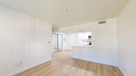 Located at 19513 N Pennsylvania Ave in Oklahoma City, OK, this single-story 2-bedroom, 1-bathroom home offers a clean, modern aesthetic throughout. The open-concept main area seamlessly connects the living room, dining space, and kitchen, all finished with light wood-style flooring that enhances the bright, airy atmosphere. Natural light enters through front-facing windows, complementing the crisp white walls.

The kitchen is well-appointed with white shaker-style cabinetry, white quartz countertops, a peninsula with an undermount sink, and a full suite of stainless steel appliances including a refrigerator, range, microwave, and dishwasher. Recessed lighting illuminates the galley-style layout efficiently.

Both bedrooms are carpeted and include ceiling fans and closets. The primary bedroom offers generous proportions with a double-door closet, while the secondary bedroom also features its own closet. The full bathroom includes a tub/shower combination with tile surround, a white vanity, and wood-style flooring. Additional utility is provided by a dedicated laundry area and utility room. With ample closet space throughout, this home balances functionality with a fresh, contemporary design.