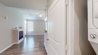 Located at 198 Mill Bayou Blvd in Lynn Haven, Florida, this single-story home offers a thoughtfully designed layout with two bedrooms, two bathrooms, and three closets. The open-concept kitchen and living area serves as the heart of the home, featuring wood-look flooring, recessed lighting, and pendant lights above a granite-topped kitchen peninsula. The kitchen is equipped with stainless steel appliances, white shaker-style cabinetry, granite countertops, and a walk-in pantry, creating a functional and attractive cooking space. The living area extends naturally from the kitchen, benefiting from natural light provided by multiple windows dressed with white blinds and a ceiling fan overhead.

The primary bedroom is generously sized with plush carpeting, a ceiling fan, and a connected bathroom. The second bedroom also features carpet flooring, a ceiling fan, and a bright window. Both bathrooms are finished with granite-topped vanities, wood-look tile flooring, and tub-shower combinations with white tile surrounds and brushed nickel fixtures. Three closets, including a walk-in with wire shelving, provide ample storage throughout the home. Neutral warm-beige walls and consistent finishes contribute to a cohesive, modern aesthetic throughout.