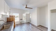 Located at 744 Beacon Ave in the heart of Los Angeles, this single-floor unit has been thoughtfully updated with a clean, modern aesthetic throughout. Light gray wood-look flooring runs seamlessly across the main living areas, creating a cohesive and airy feel that complements the crisp white walls.

The living area is bright and open, benefiting from multiple windows fitted with blinds that allow natural light to pour in. A ceiling fan provides year-round comfort, while a wall-mounted heater adds practical functionality. The space flows naturally into a well-appointed kitchen featuring white shaker-style cabinetry, a classic white subway tile backsplash, dark countertops, and a stainless steel sink — a clean and timeless combination.

The bedroom is generously proportioned, with its own ceiling fan, a built-in closet, and continued wood-look flooring, offering a calm and restful retreat. The bathroom is finished in a bright, all-white palette with large-format marble-look tile flooring, a white vanity with a mirror, and a window that brings in natural light while maintaining privacy.

Overall, the space presents a cohesive, freshly renovated interior that balances practicality with understated style, making it a functional and attractive urban dwelling in Los Angeles.