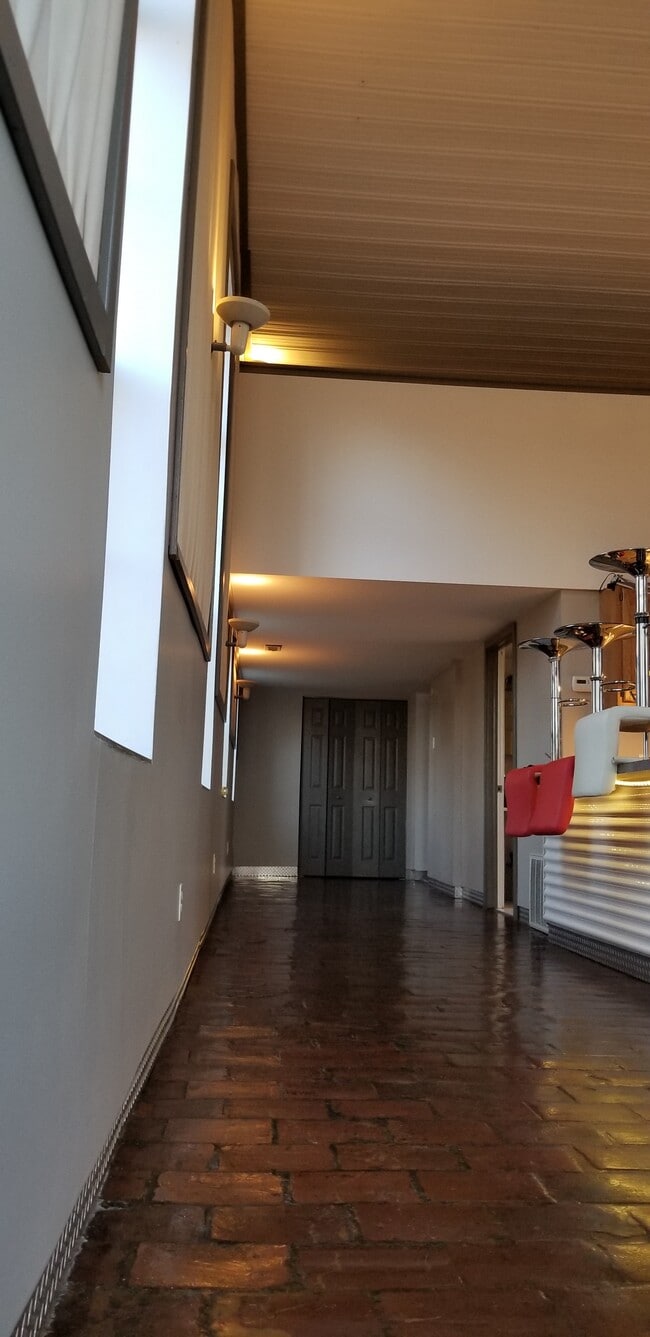 Breakfast bar, storage and door to balcony - 277 Bluff St
