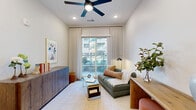 Located at 1201 Hillside Avenue in Nashville's 37203 zip code, this thoughtfully designed one-bedroom, one-bathroom residence offers a smart, efficient layout across a single floor. The open-concept living, dining, and kitchen area serves as the heart of the home, anchored by a sleek white kitchen with shaker-style cabinetry, a subway tile backsplash, quartz countertops, a large center island, stainless steel appliances, and pendant lighting with brass accents. Warm hardwood-style flooring flows throughout, complementing the bright, neutral palette. The living area features recessed lighting and a ceiling fan, and opens directly onto a private balcony through sliding glass doors, allowing abundant natural light and outdoor views. The bedroom is a calm, well-proportioned retreat with soft carpet, a large window with outdoor views, and access to two closets. The bathroom offers a clean, modern aesthetic with a quartz-topped double vanity, a large mirror, and a tiled walk-in shower. A utility room adds practical convenience. Two additional closets provide ample storage throughout the residence. The overall ambiance is contemporary and polished, ideal for comfortable urban living in Nashville.