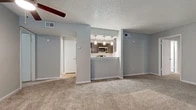 Located at 408 Green Oaks Cir in Arlington, TX, this single-story residence offers two bedrooms and two bathrooms within a thoughtfully arranged floor plan. The living room serves as the central gathering space, featuring carpet flooring, a ceiling fan with light fixture, a fireplace with a tiled hearth, and windows with blinds that allow natural light. A pass-through opening connects the living area to the galley-style kitchen, which is equipped with dark cabinetry, white countertops, a white tile backsplash, light wood-style flooring, and stainless steel appliances including a refrigerator, range, microwave, and dishwasher.

The primary bedroom is generously sized, with carpet flooring, a ceiling fan, a window, and access to a dedicated walk-in closet. The second bedroom also features carpet, a ceiling fan, and a window. Both bathrooms include wood-style tile flooring, and at least one features a full tub-shower combination with large-format tile surround and chrome fixtures. A hallway connects the bedrooms and bathrooms, maintaining an efficient layout. Textured ceilings and neutral gray walls are consistent throughout, creating a cohesive and clean aesthetic.