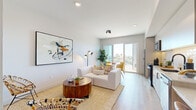 Located at 4250 Oregon St in San Diego's vibrant North Park neighborhood, this single-floor unit showcases a clean, contemporary design with light wood-style flooring and crisp white walls that run throughout the space. The open-concept layout connects the living area, kitchen, and dining zone seamlessly, creating an airy and functional flow.

The living room features recessed and track lighting, generous wall space suited for artwork, and direct sightlines to the balcony through large sliding glass doors that flood the interior with natural light. A built-in desk area adjacent to the kitchen offers a dedicated workspace, complemented by open wood shelving for storage and display.

The kitchen is well-appointed with stainless steel appliances including a full-size refrigerator, electric range, microwave, and dishwasher. Flat-front cabinetry in a light finish, a textured tile backsplash, and a deep-basin sink complete the modern aesthetic.

The dining area sits directly beside the sliding doors, providing seamless access to the private balcony, which offers open views of the surrounding San Diego neighborhood. The bathroom features light wood cabinetry, a single vanity with a white countertop, a tub-shower combination, and wood-look flooring, maintaining the cohesive modern palette found throughout the unit.