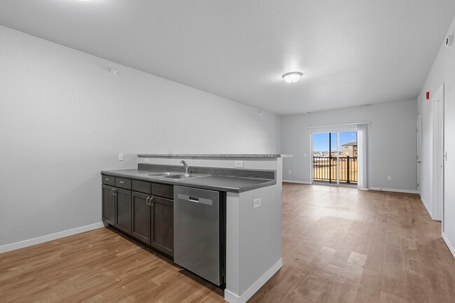 Step into modern elegance at North Highlands Apartments. This spacious kitchen features sleek countertops and contemporary finishes, perfect for culinary enthusiasts. Ideal for hosting gatherings or enjoying quiet meals at home. Explore your new lifestyle today! - North Highlands Apartments and Villas
