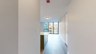 Located at 400 E South Water St, this single-floor residence offers a well-designed layout with a cohesive modern aesthetic. Light-toned hardwood-style flooring runs throughout, unifying each area of the space and complementing the clean, neutral color palette on the walls and ceilings.

The kitchen is a standout feature, outfitted with gray shaker-style cabinetry, white quartz countertops, and a full suite of stainless steel appliances including a gas range, microwave, dishwasher, and refrigerator. A subway tile backsplash adds texture, while a central island provides additional prep and storage space. Generous cabinet storage, including tall pantry-style units, ensures practical functionality.

The main living area is bathed in natural light courtesy of expansive floor-to-ceiling windows with sleek black frames, offering open views of the surrounding Chicago cityscape. The bright, airy atmosphere is further enhanced by the unit's elevated position.

The bathroom features a full soaking tub with a tiled surround, brushed nickel fixtures, and wood-look flooring that ties cohesively to the rest of the unit. The overall ambiance of the space is contemporary and refined, with a clean, move-in-ready presentation throughout.