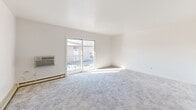 Located at 3715 W 123rd Pl in Alsip, IL, this well-laid-out one-bedroom, one-bathroom unit offers a comfortable and functional single-floor living experience. The spacious living room is bright and airy, featuring plush carpeting, a baseboard heating system, a wall-mounted air conditioning unit, and a sliding glass door that opens onto a private balcony with views of the surrounding community. The adjacent dining area is defined by an elegant gold chandelier and flows seamlessly into the galley-style kitchen, which is outfitted with dark cabinetry, light stone countertops, a double sink, tile flooring, and stainless steel appliances including a refrigerator and range. The generously sized bedroom provides ample natural light through a dedicated window, wall-to-wall carpeting, baseboard heat, a wall AC unit, and an impressive wall of double closets offering abundant storage. Four closets total are distributed throughout the unit for added convenience. The full bathroom features tile flooring, a warm wood vanity with granite countertop, a medicine cabinet with lighted mirror, and a glass-enclosed shower stall. An entrance area with an additional closet completes the layout, creating a practical and welcoming home.