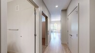 Located at 18 W 15th St in Minneapolis, MN, this efficiently designed studio offers a well-organized single-floor layout that maximizes every square foot. Light hardwood-style flooring runs throughout the entire unit, lending a clean, cohesive aesthetic to the space.

The kitchen is a standout feature, outfitted with white shaker-style cabinetry, a white quartz countertop, and a classic subway tile backsplash. Stainless steel appliances — including a refrigerator, electric range, over-the-range microwave, and dishwasher — provide a full suite of modern conveniences. A pendant light fixture and under-cabinet track lighting illuminate the workspace, while a window overlooking greenery brings in natural light.

The open living area is bright and versatile, featuring track lighting on the ceiling and a wall-mounted HVAC unit. Neutral warm-toned walls create a calm, inviting atmosphere that adapts easily to a variety of uses.

The bathroom is clean and contemporary, with white shaker vanity cabinetry, a white quartz countertop, brushed nickel hardware, a large mirror, and a full tub/shower combo. Consistent flooring and neutral tones carry the unit's cohesive design language into this space as well.

Overall, the unit presents a fresh, modern finish palette well-suited for urban living in the heart of Minneapolis.
