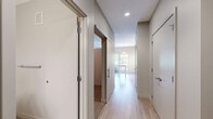 Located at 18 W 15th St in Minneapolis, MN, this efficiently designed studio offers a well-organized single-floor layout that maximizes every square foot. Light hardwood-style flooring runs throughout the entire unit, lending a clean, cohesive aesthetic to the space.

The kitchen is a standout feature, outfitted with white shaker-style cabinetry, a white quartz countertop, and a classic subway tile backsplash. Stainless steel appliances — including a refrigerator, electric range, over-the-range microwave, and dishwasher — provide a full suite of modern conveniences. A pendant light fixture and under-cabinet track lighting illuminate the workspace, while a window overlooking greenery brings in natural light.

The open living area is bright and versatile, featuring track lighting on the ceiling and a wall-mounted HVAC unit. Neutral warm-toned walls create a calm, inviting atmosphere that adapts easily to a variety of uses.

The bathroom is clean and contemporary, with white shaker vanity cabinetry, a white quartz countertop, brushed nickel hardware, a large mirror, and a full tub/shower combo. Consistent flooring and neutral tones carry the unit's cohesive design language into this space as well.

Overall, the unit presents a fresh, modern finish palette well-suited for urban living in the heart of Minneapolis.