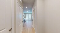 Located at 7777 Manderville Ln in Dallas, TX, this efficiently designed single-floor studio offers a thoughtfully organized layout that maximizes every square foot. The open-concept living area is anchored by light wood-look flooring that runs throughout the space, complemented by soft neutral wall tones and recessed lighting that create a clean, airy ambiance. A ceiling fan with integrated lighting in the main living area enhances comfort, while a set of French doors and an adjacent window flood the room with natural light and provide access to the outdoors.

The contemporary kitchen is a standout feature, showcasing a sleek two-tone design with warm wood lower cabinetry paired with crisp white upper cabinets and black hardware. A textured gray scallop-patterned tile backsplash adds visual interest, while white quartz countertops provide a clean work surface. Stainless steel appliances — including a refrigerator, range, microwave, and dishwasher — complete the modern culinary setup. A dedicated pantry offers additional storage convenience.

The bathroom is finished with light tile flooring and features a full soaking tub with an overhead shower, white subway tile surround, and wood-toned overhead cabinetry with black hardware. A sliding door closet with built-in rod and shelving provides organized storage within the main living space.