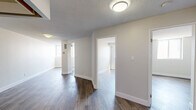 Located at 295 Dufferin St, Suite 509 in Toronto's vibrant King West neighbourhood, this 2-bedroom, 1-bathroom unit offers a practical and modern living space across a single floor. The interior is finished with light wood-look laminate flooring throughout the main living areas and bedrooms, complemented by crisp white walls and clean baseboards that give the unit a fresh, contemporary feel.

The kitchen is efficiently designed with white cabinetry, dark tile backsplash, polished dark tile flooring, and a full suite of stainless steel appliances including a range, over-the-range microwave, and dishwasher — making it both functional and stylish. The bathroom features a modern vanity with wood-toned cabinetry and white countertop, subway tile walls, dark slate-style floor tiles, and a bathtub with tiled surround, creating a clean and classic aesthetic.

Both bedrooms are bright and offer a comfortable footprint, with windows providing natural light and urban views of the surrounding Toronto skyline. The primary bedroom offers a cozy yet practical space, while the second bedroom is similarly well-proportioned. The neutral colour palette throughout the unit creates a versatile canvas well-suited for a variety of furnishing styles.